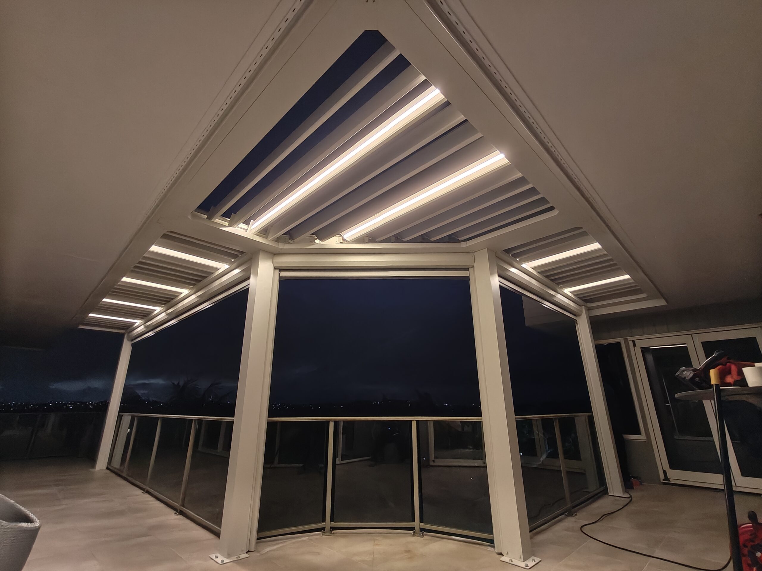 A Coastal Transformation: Custom Pergola with Retractable Blinds for a Seaside Home