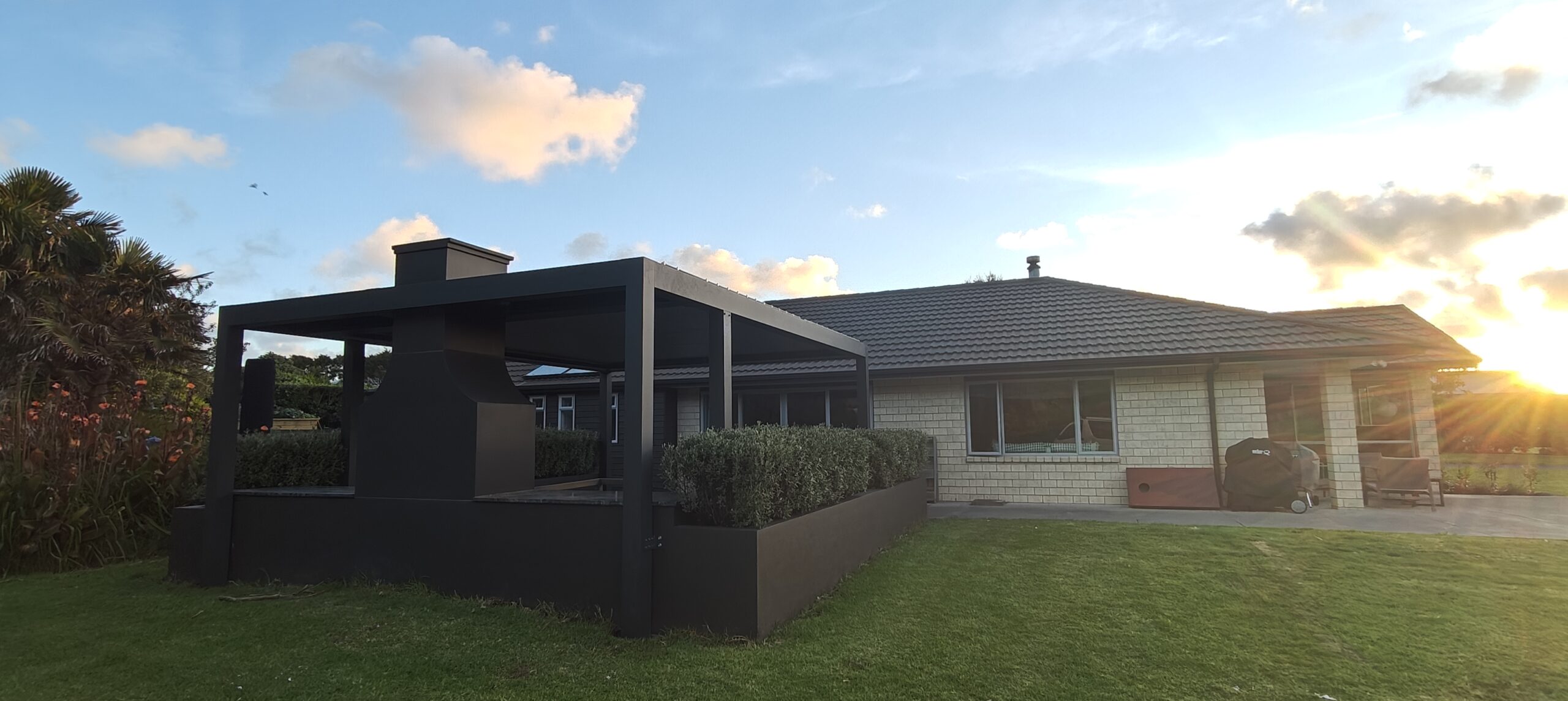 A Custom Pergola That Frames a Backyard BBQ Area