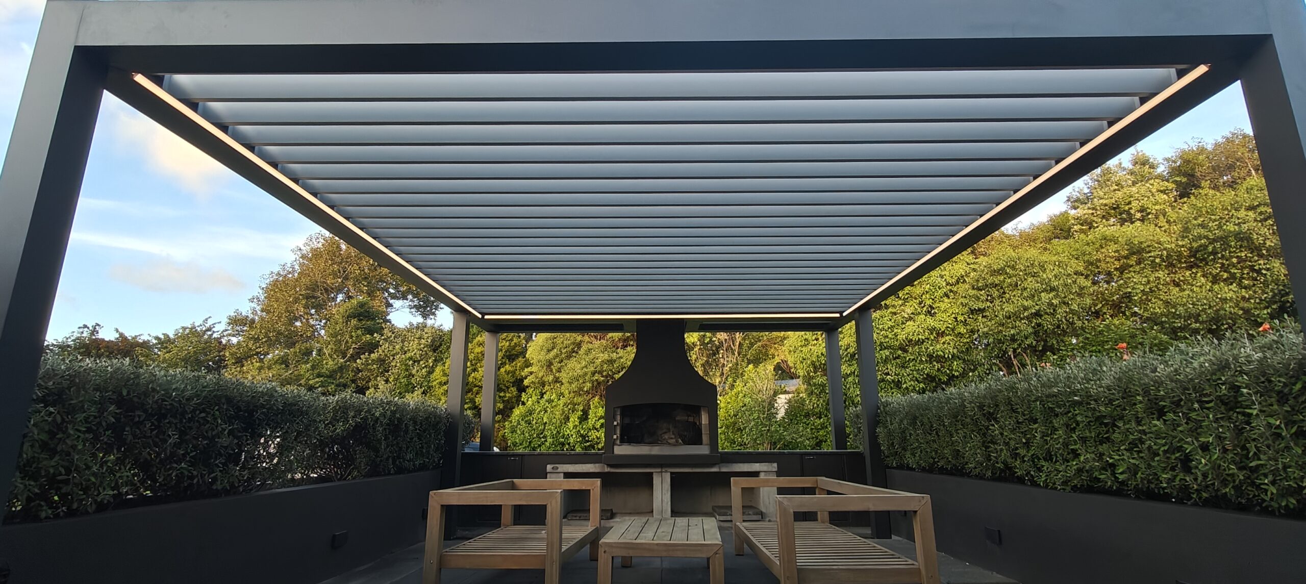 A Custom Pergola That Frames a Backyard BBQ Area