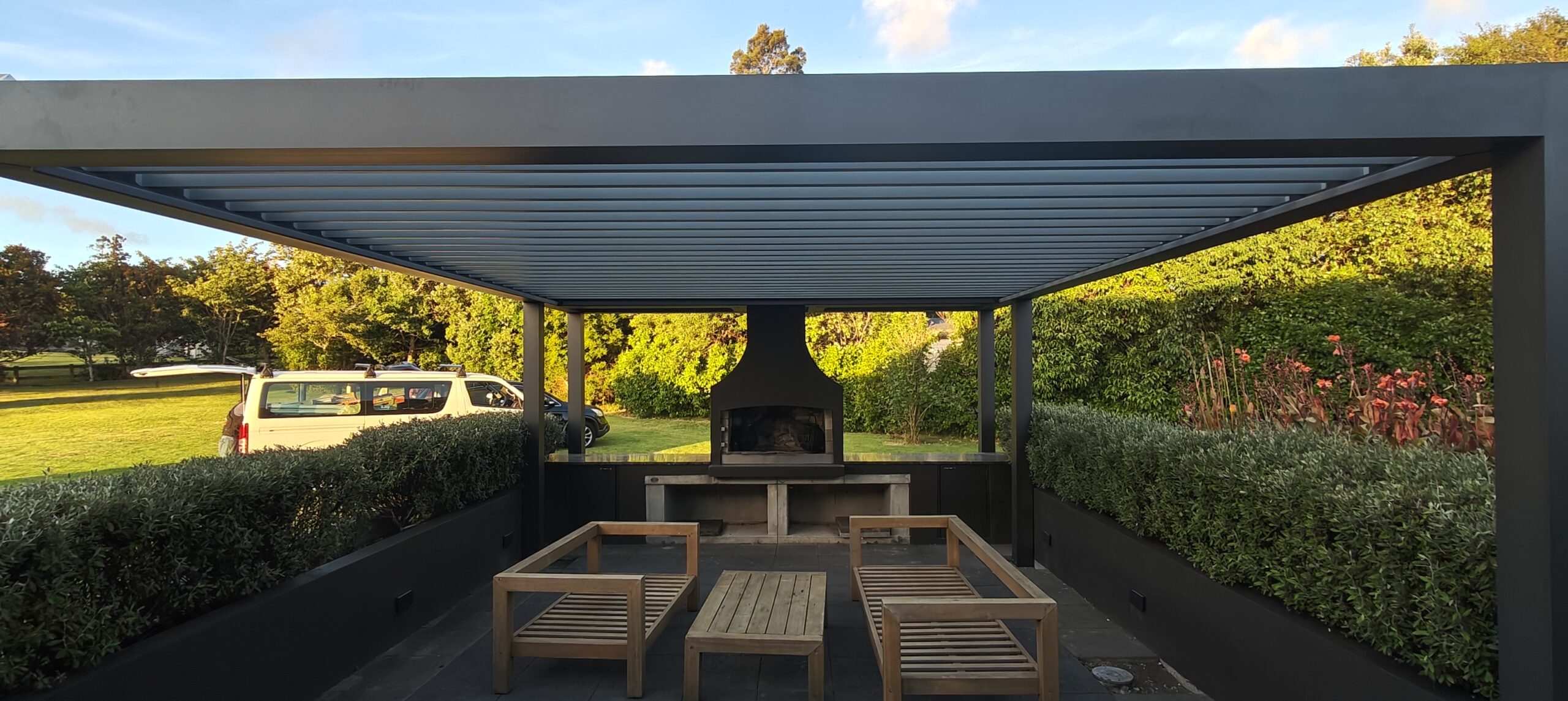 A Custom Pergola That Frames a Backyard BBQ Area